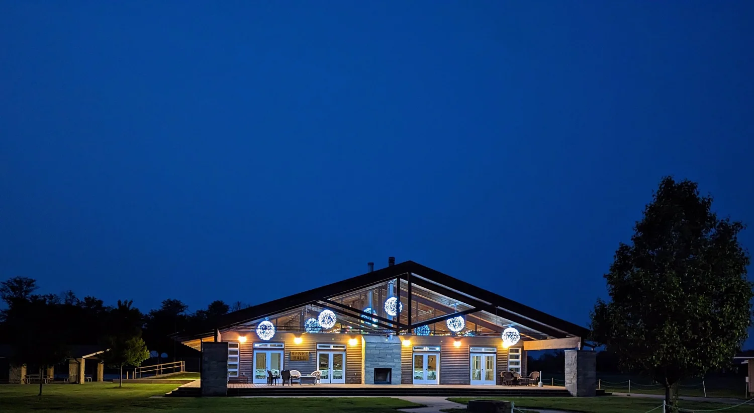 A picture in the evening of our wedding venue, Hanke Hall, lit from within.